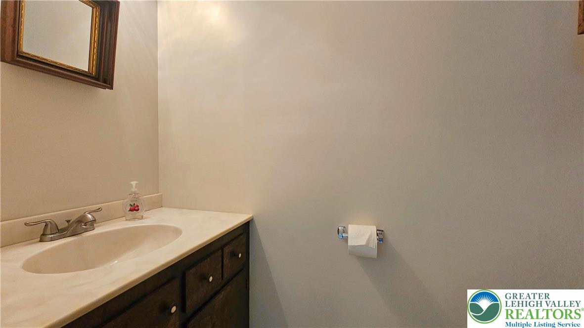 2810 County Line Road Riegelsville, PA 18077 - Photo 5 of 7 A compact vanity with a pristine countertop and integrated sink provides practical elegance in this private space.