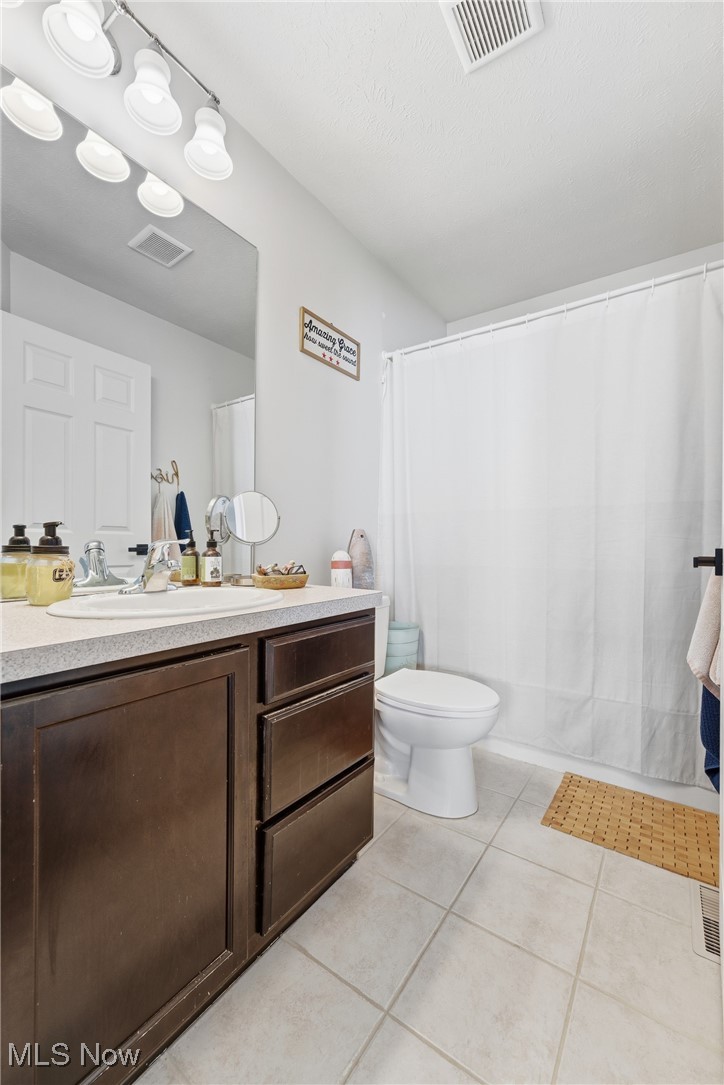 4038 Gardiner Run Akron, OH 44321 - Photo 19 of 38 Full bath with light tile patterned flooring, vanity, and a shower with shower curtain