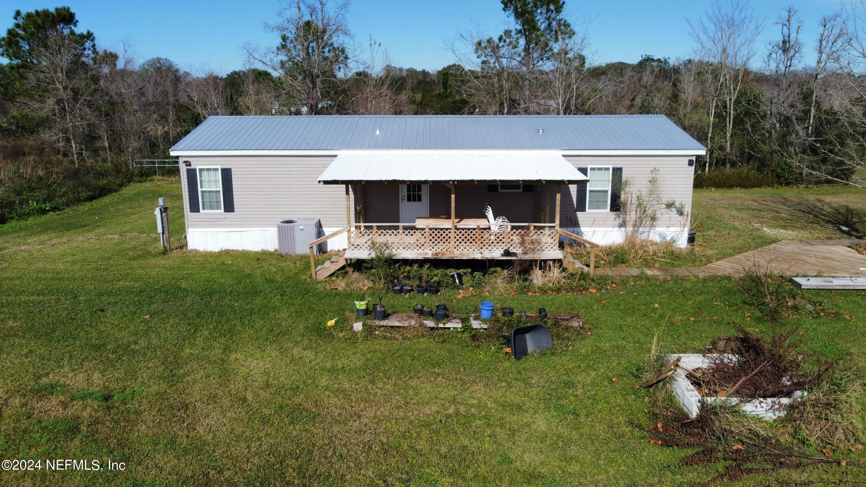 a aerial view of a house with garden and trees