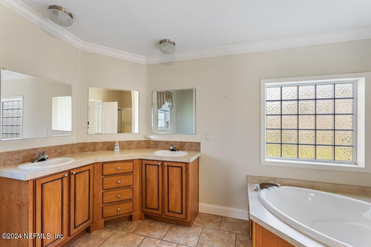 175 Hawk Lane Hastings, FL 32145 - Photo 12 of 40 a spacious bathroom with a granite countertop sink and a bathtub