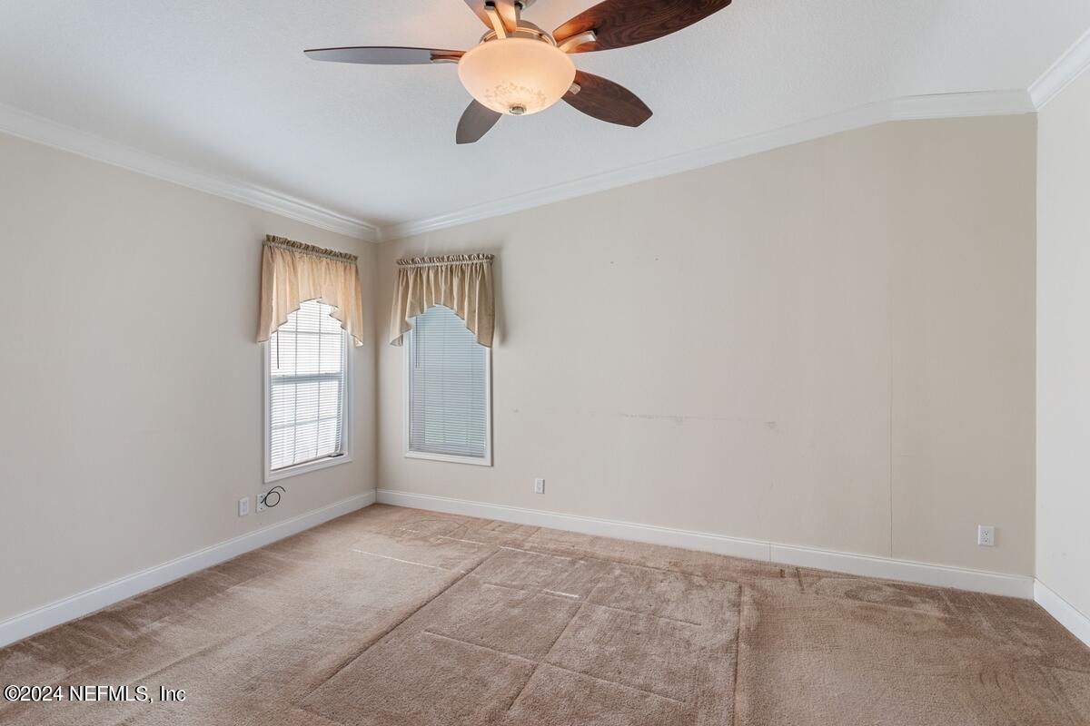 175 Hawk Lane Hastings, FL 32145 - Photo 15 of 40 wooden floor in an empty room with a window