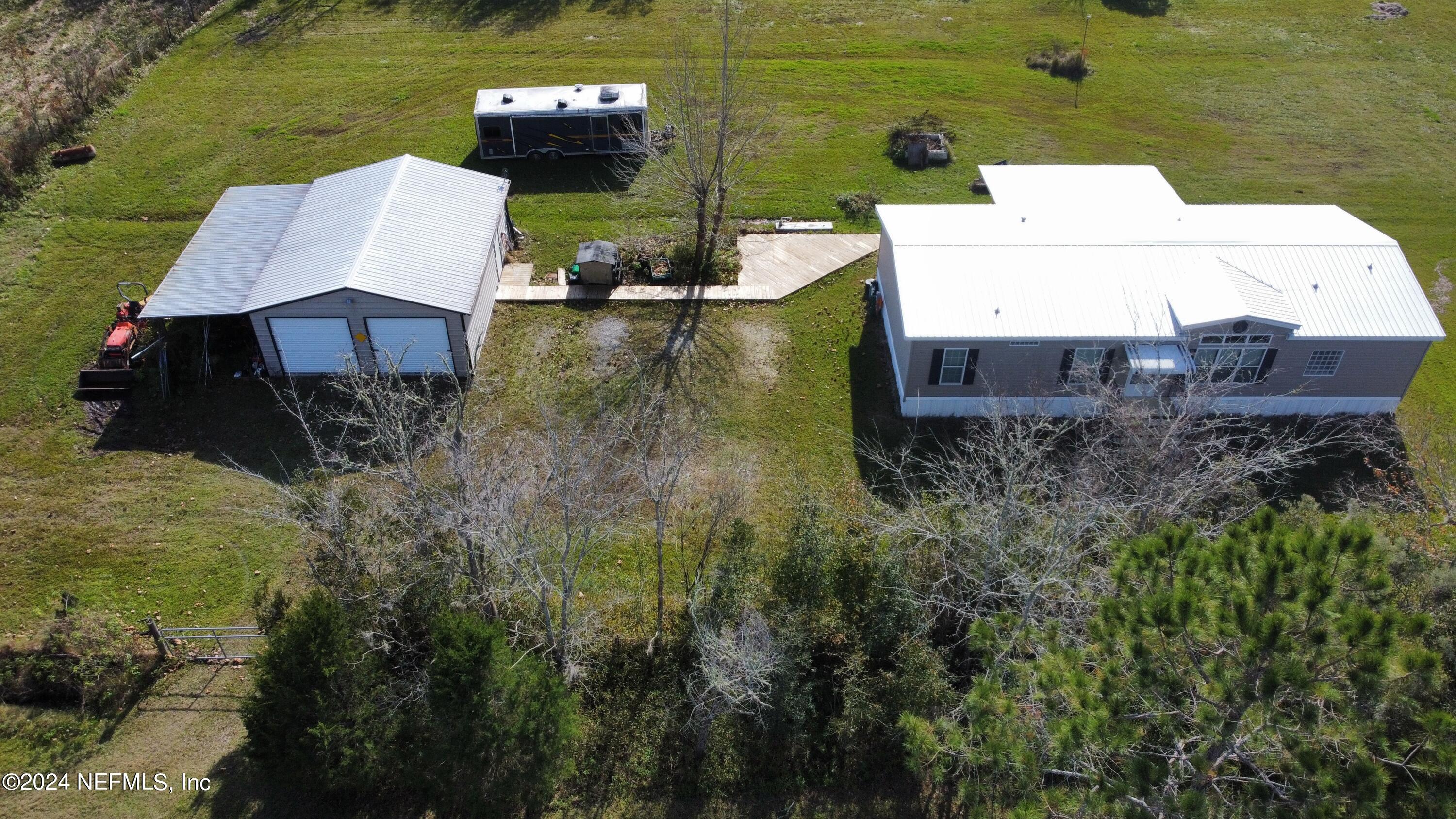 175 Hawk Lane Hastings, FL 32145 - Photo 3 of 40 an aerial view of a house with pool a yard and lake view