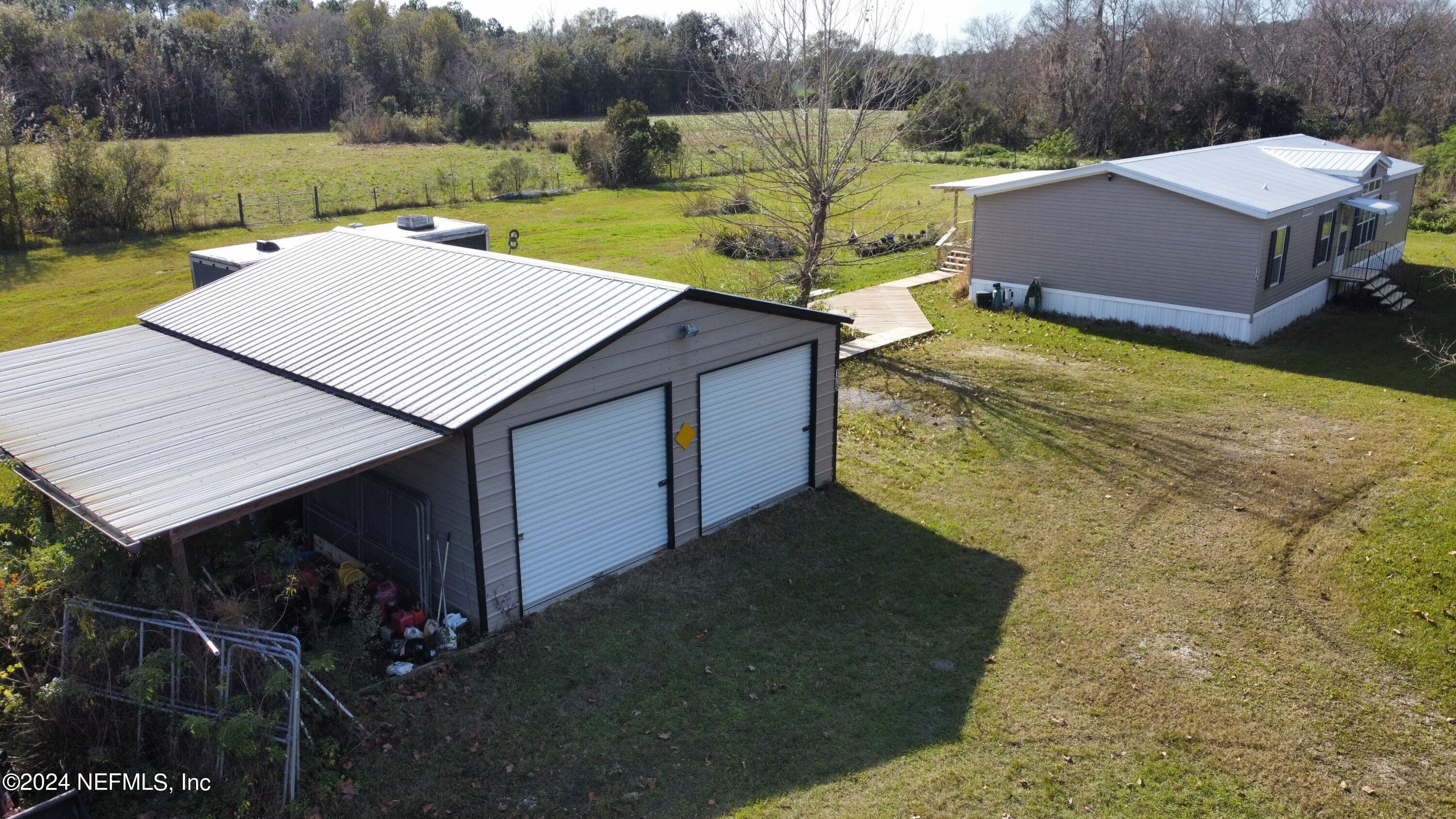 175 Hawk Lane Hastings, FL 32145 - Photo 32 of 40 a view of a house with pool and a yard