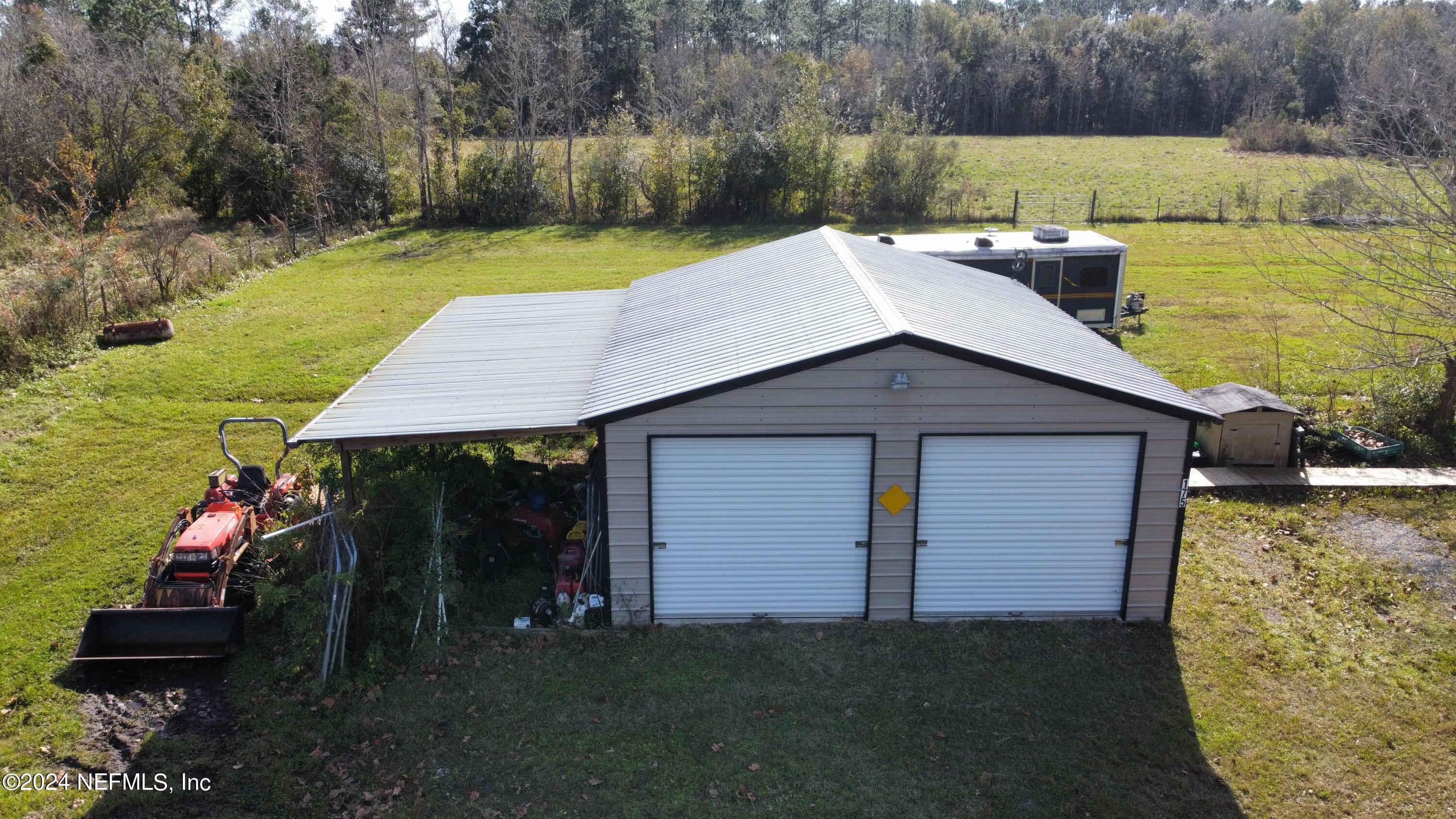 175 Hawk Lane Hastings, FL 32145 - Photo 33 of 40 a backyard of a house with lots of green space and lake view