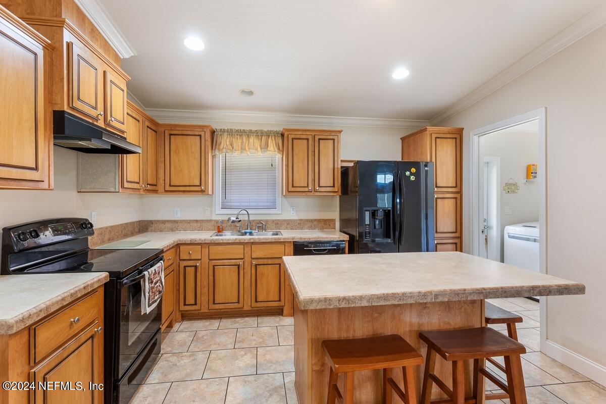 175 Hawk Lane Hastings, FL 32145 - Photo 7 of 40 a kitchen with a stove a sink a refrigerator and a cabinets