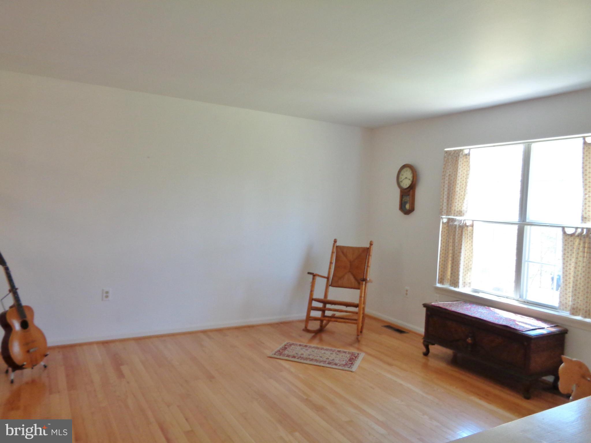 2000 Kings Landing Road Huntingtown, MD 20639 - Photo 3 of 24 a room with a window and wooden floor