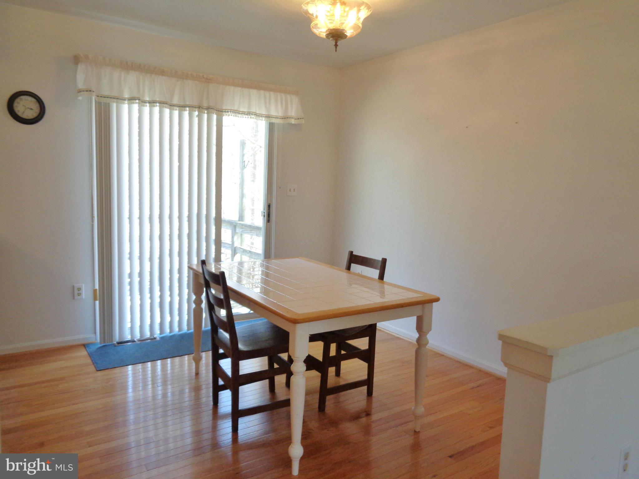 2000 Kings Landing Road Huntingtown, MD 20639 - Photo 5 of 24 a view of a dining room with furniture and wooden floor