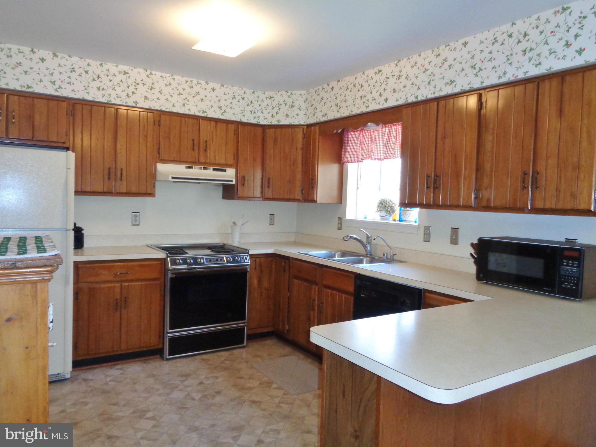 2000 Kings Landing Road Huntingtown, MD 20639 - Photo 6 of 24 a kitchen with stainless steel appliances granite countertop a sink stove and refrigerator