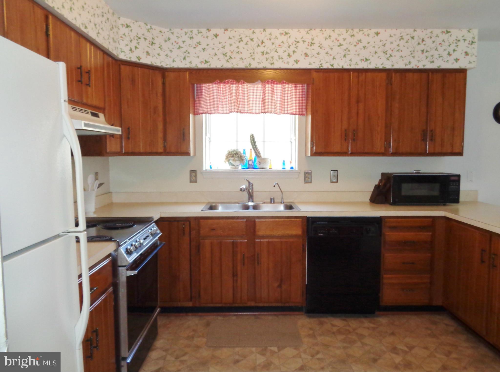 2000 Kings Landing Road Huntingtown, MD 20639 - Photo 7 of 24 a kitchen with stainless steel appliances granite countertop a sink stove and refrigerator