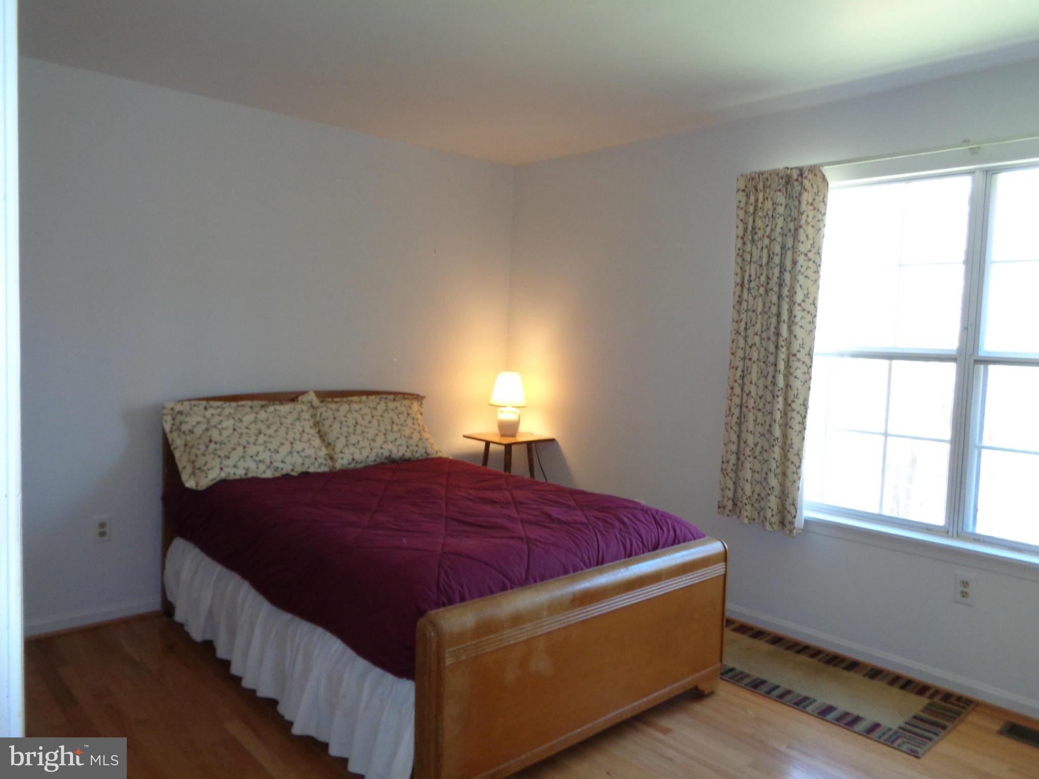 2000 Kings Landing Road Huntingtown, MD 20639 - Photo 9 of 24 a bed sitting in a bedroom next to a window