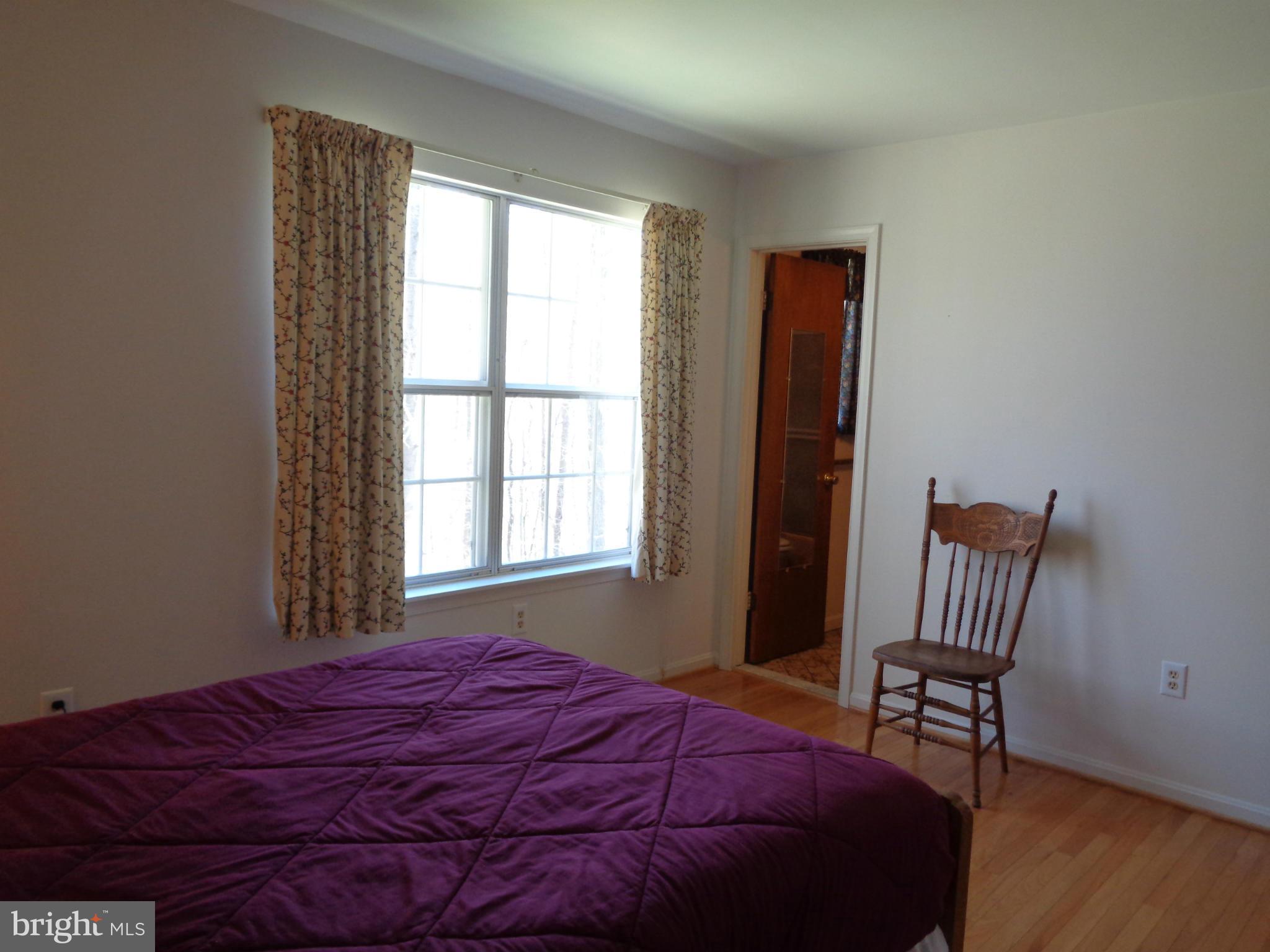 2000 Kings Landing Road Huntingtown, MD 20639 - Photo 10 of 24 a bed sitting in a bedroom next to a window