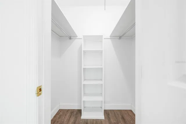 a view of walk in closet with empty racks