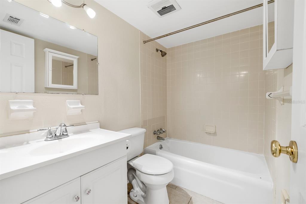 1700 Southwest 16th Court, Unit L26 Gainesville, FL 32608 - Photo 14 of 24 a bathroom with a sink a toilet and shower