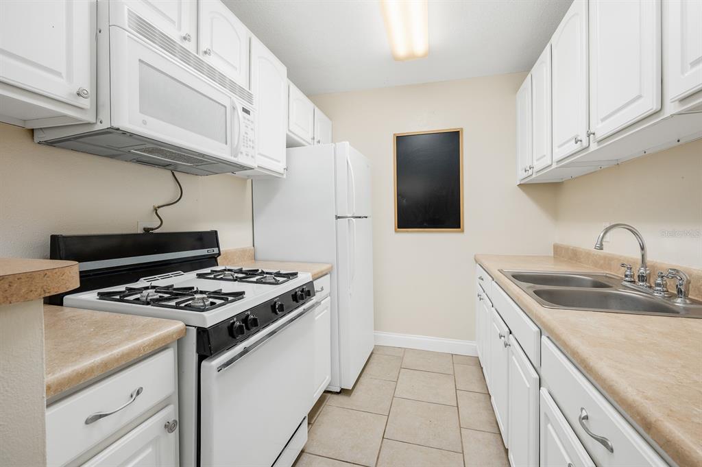 1700 Southwest 16th Court, Unit L26 Gainesville, FL 32608 - Photo 7 of 24 a kitchen with stainless steel appliances granite countertop a sink stove and cabinets