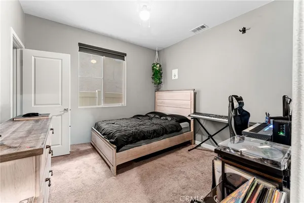 a living room with furniture a window and a potted plant