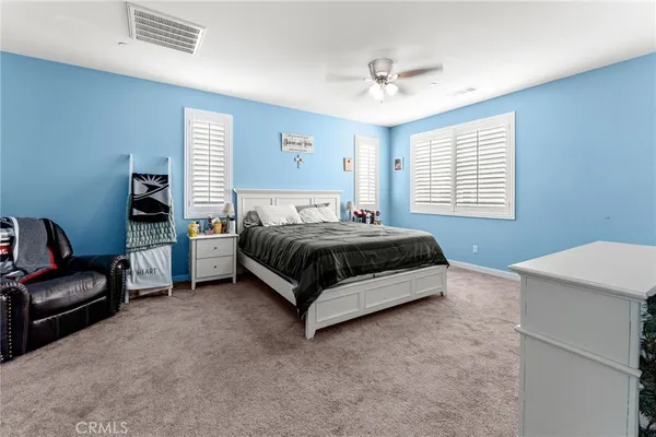 a bedroom with a bed and a television