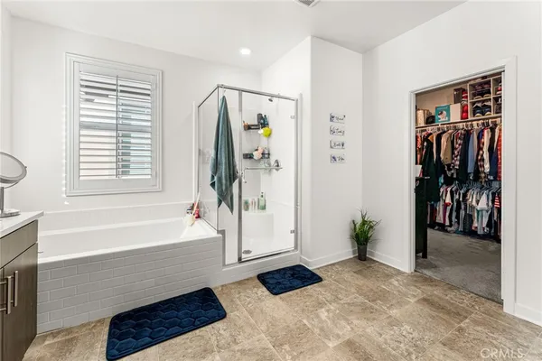 a white toilet sitting next to a bath tub
