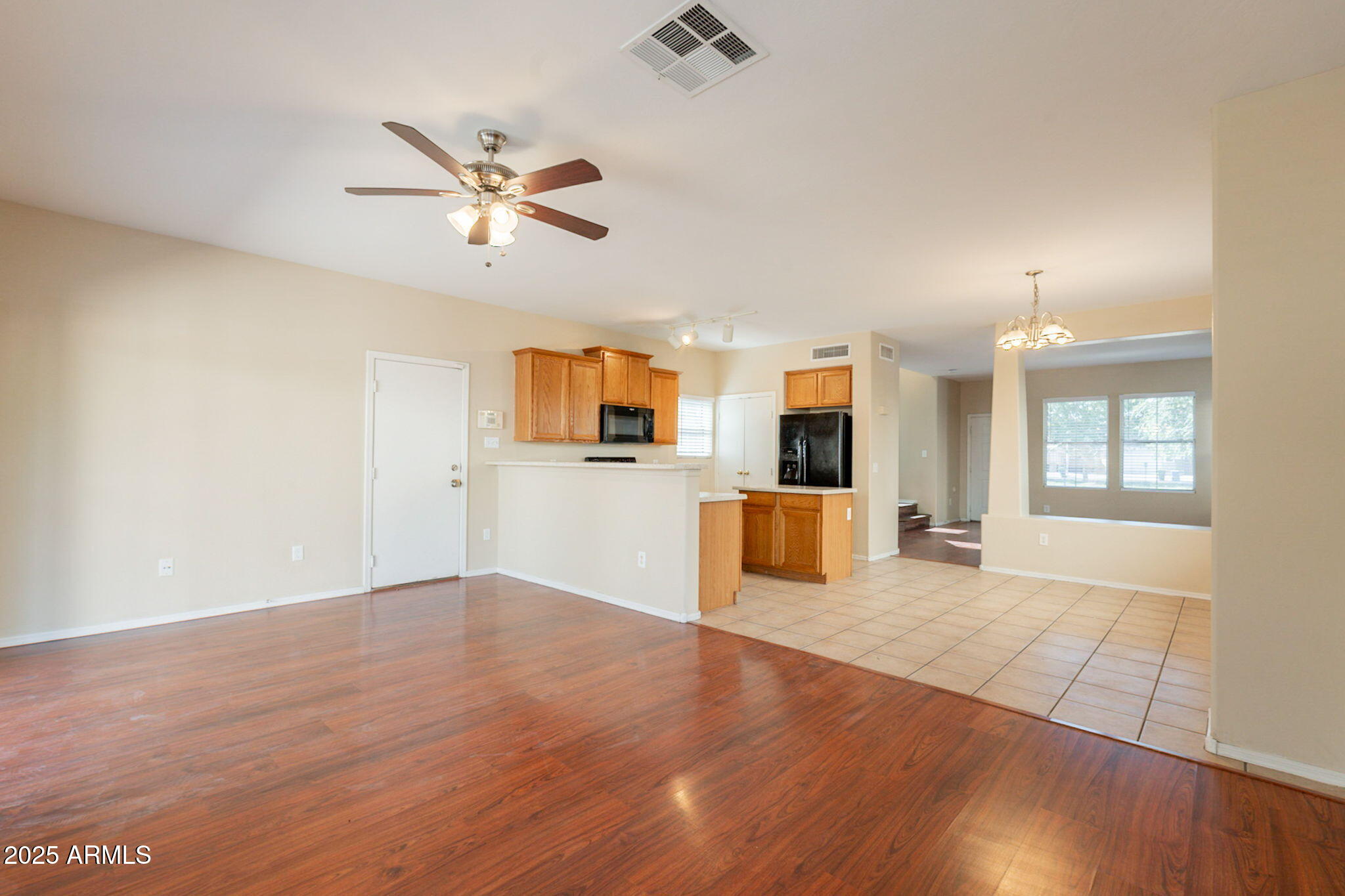 4010 West Fremont Rd. Phoenix, AZ 85041 - Photo 13 of 46 a view of a kitchen with wooden floor and a ceiling fan