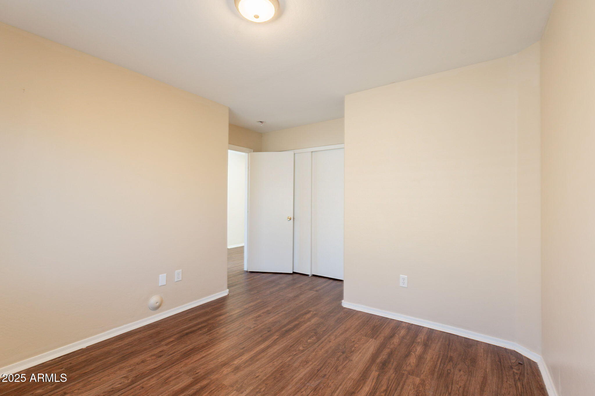 4010 West Fremont Rd. Phoenix, AZ 85041 - Photo 24 of 46 a view of an empty room with wooden floor