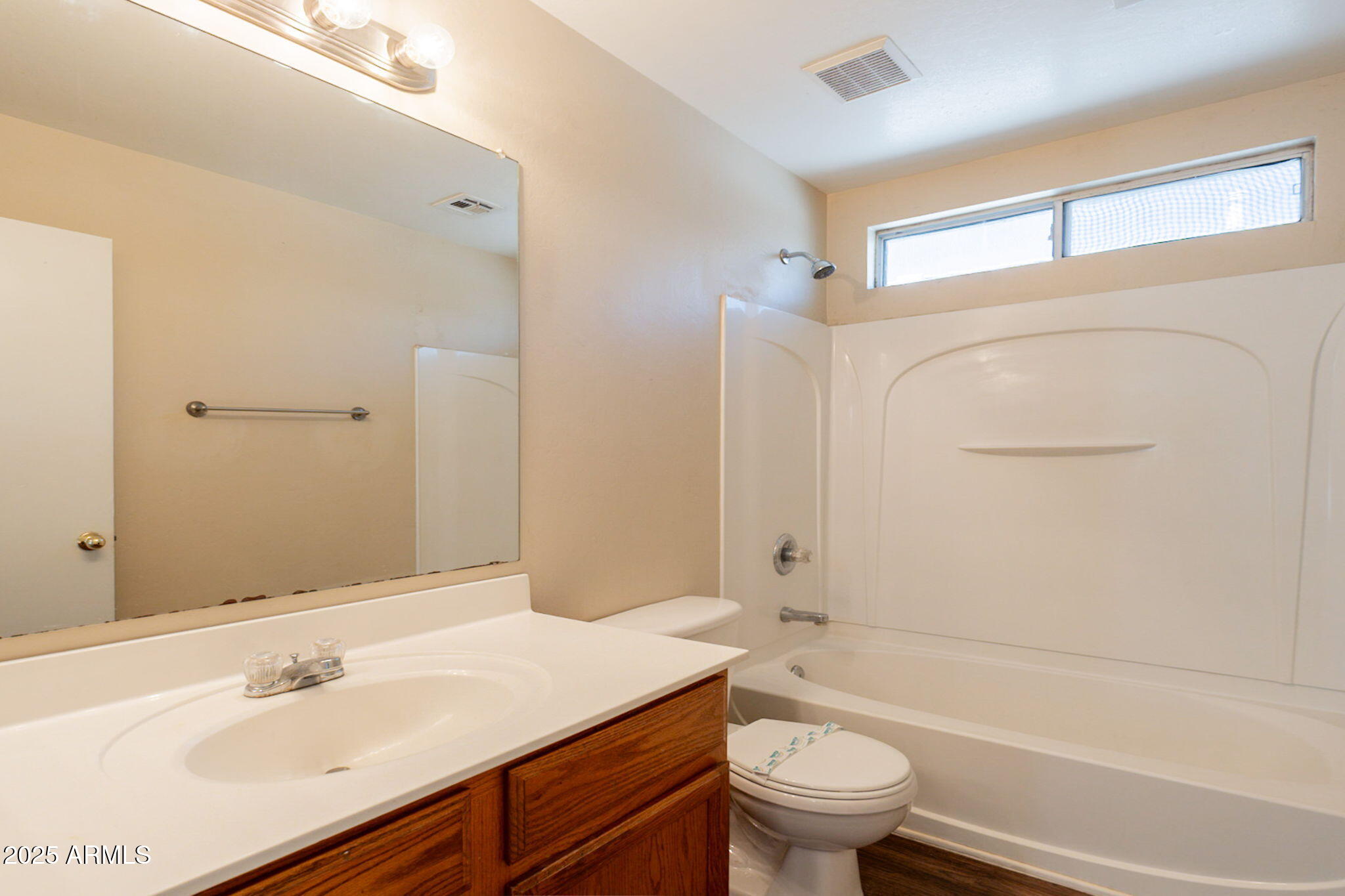 4010 West Fremont Rd. Phoenix, AZ 85041 - Photo 25 of 46 a bathroom with a sink a toilet and a large mirror
