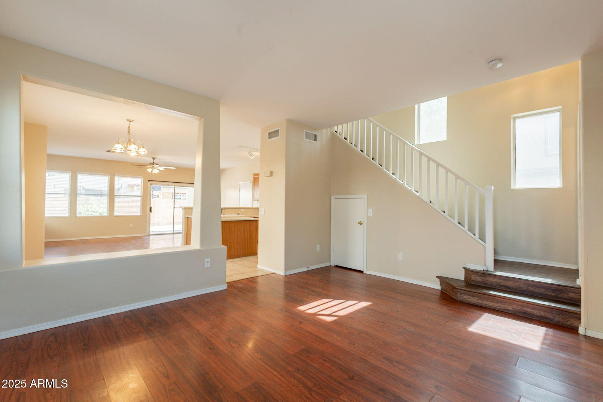4010 West Fremont Rd. Phoenix, AZ 85041 - Photo 4 of 46 a view of empty room with wooden floor and fan