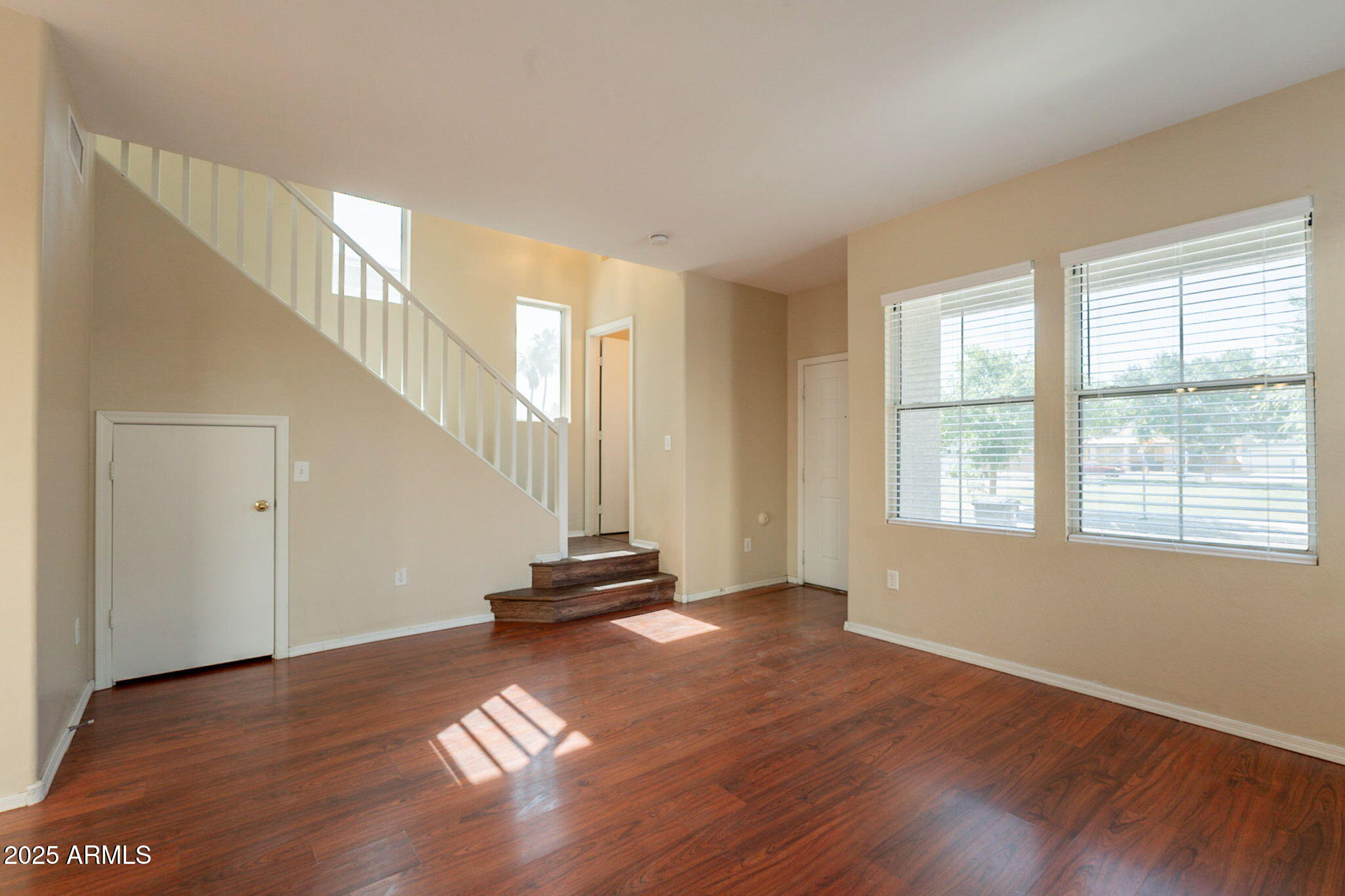 4010 West Fremont Rd. Phoenix, AZ 85041 - Photo 5 of 46 a view of an empty room with wooden floor and a window