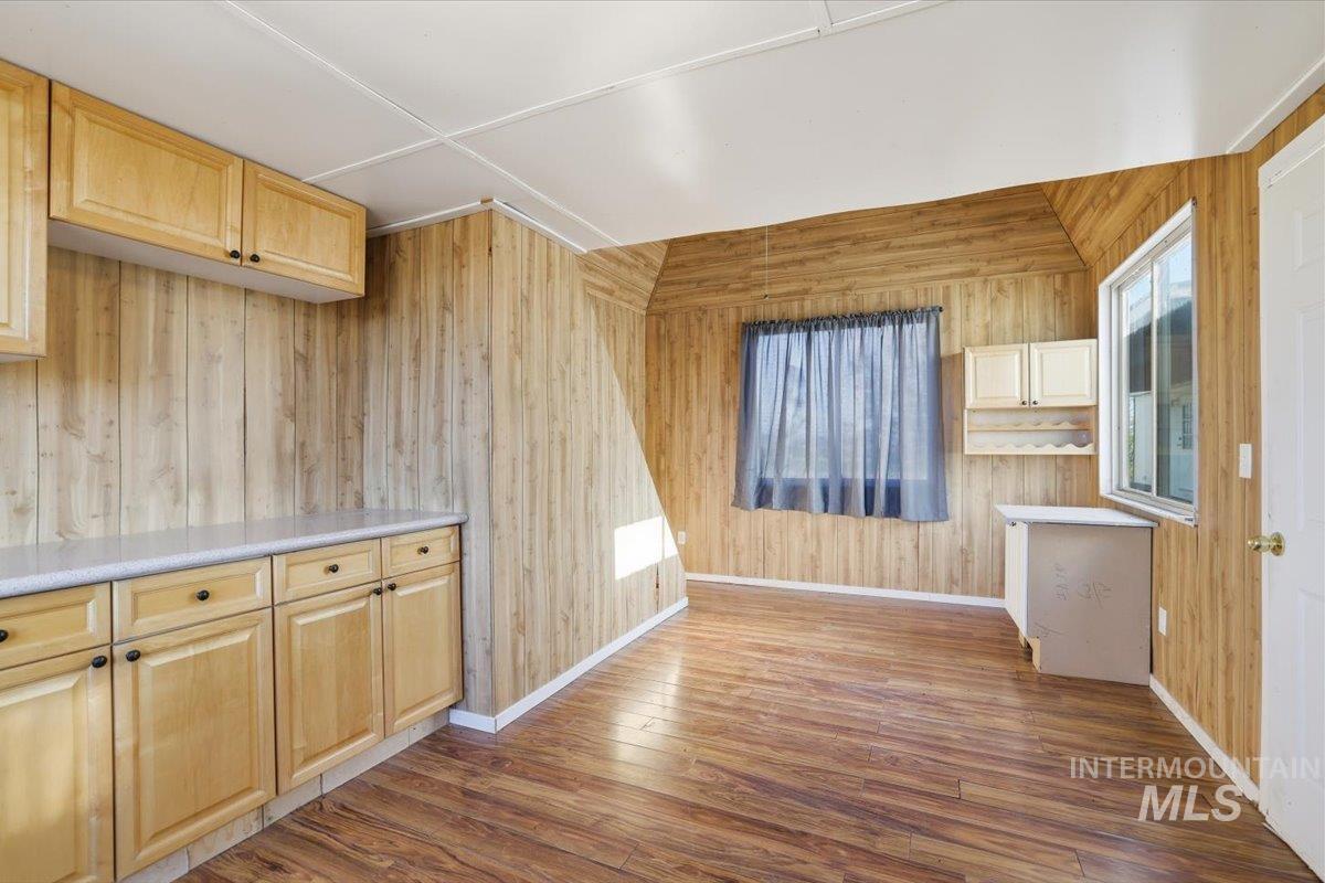 4207 West Pershall Road Marsing, ID 83639 - Photo 38 of 42 Unfurnished dining area featuring wooden walls and hardwood / wood-style flooring