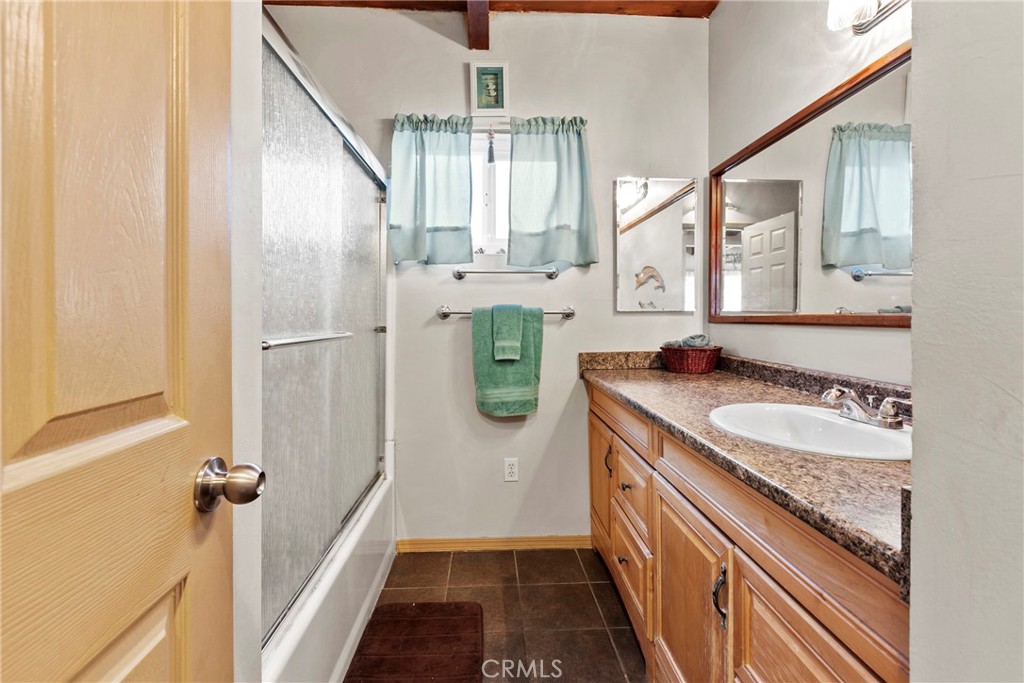 3201 Tide Avenue Morro Bay, CA 93442 - Photo 13 of 30 a bathroom with a granite countertop sink and a mirror