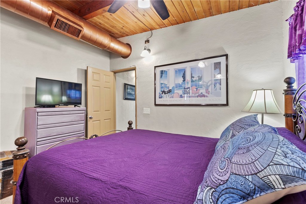 3201 Tide Avenue Morro Bay, CA 93442 - Photo 15 of 30 a bedroom with a large bed and a flat screen tv