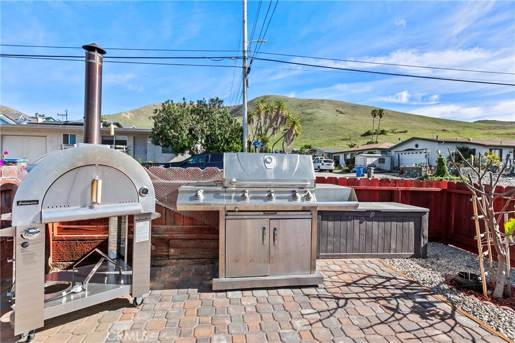 3201 Tide Avenue Morro Bay, CA 93442 - Photo 19 of 30 a view of a patio with table and chairs potted plants
