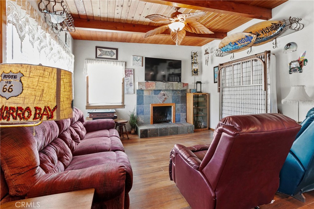3201 Tide Avenue Morro Bay, CA 93442 - Photo 5 of 30 a living room with furniture a flat screen tv and a fireplace