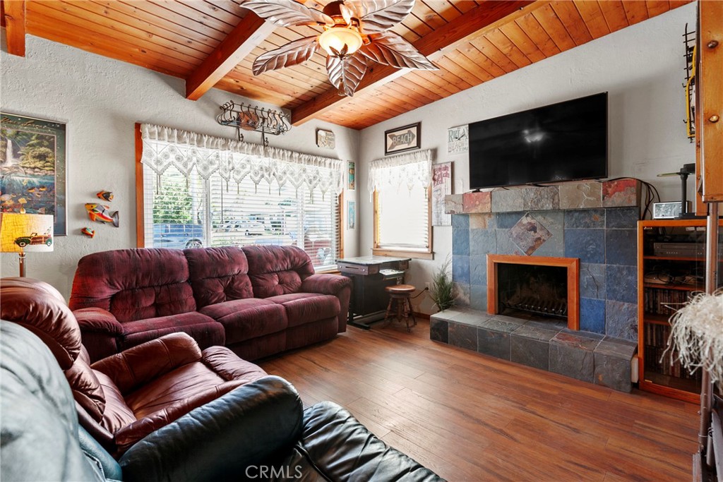 3201 Tide Avenue Morro Bay, CA 93442 - Photo 6 of 30 a living room with furniture a flat screen tv and a fireplace