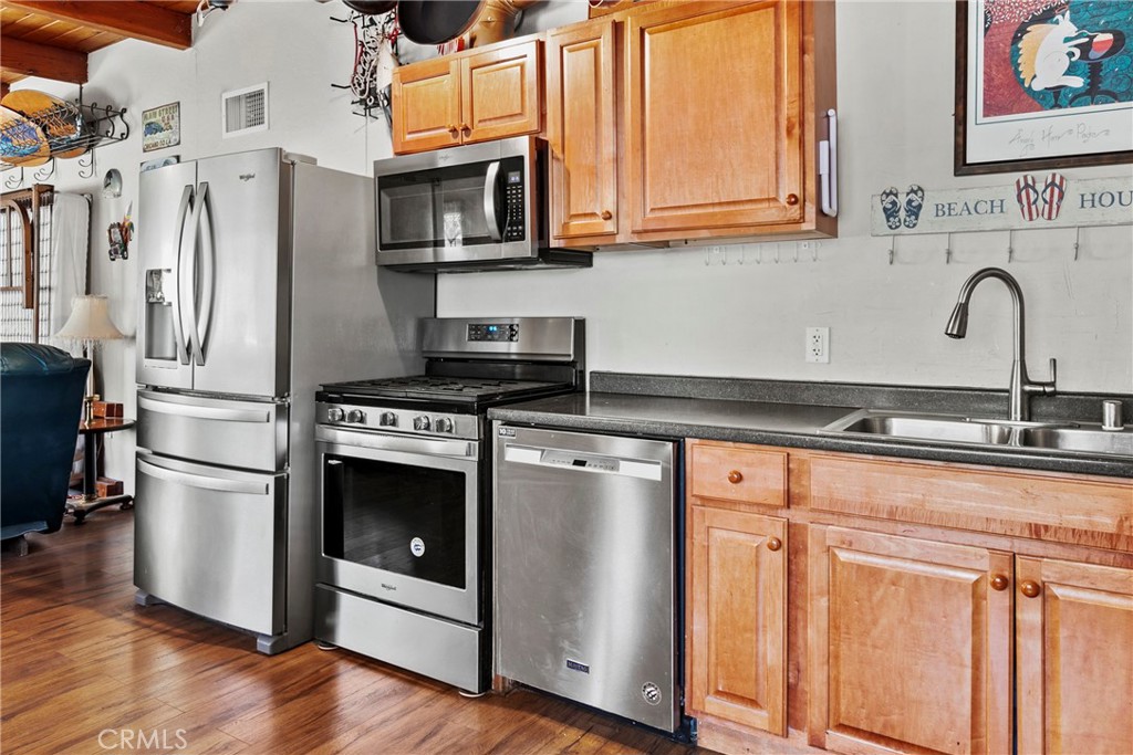 3201 Tide Avenue Morro Bay, CA 93442 - Photo 9 of 30 a kitchen with stainless steel appliances granite countertop a refrigerator sink and stove
