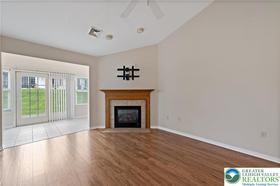 1300 Upstream Farm Road Easton, PA 18040 - Photo 12 of 29 a view of an empty room with wooden floor fireplace and a window