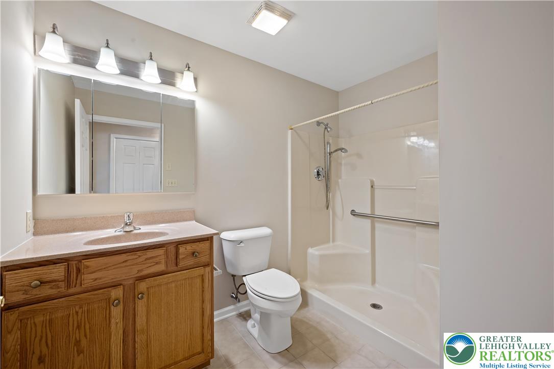 1300 Upstream Farm Road Easton, PA 18040 - Photo 15 of 29 a bathroom with a granite countertop sink toilet a mirror a vanity and shower