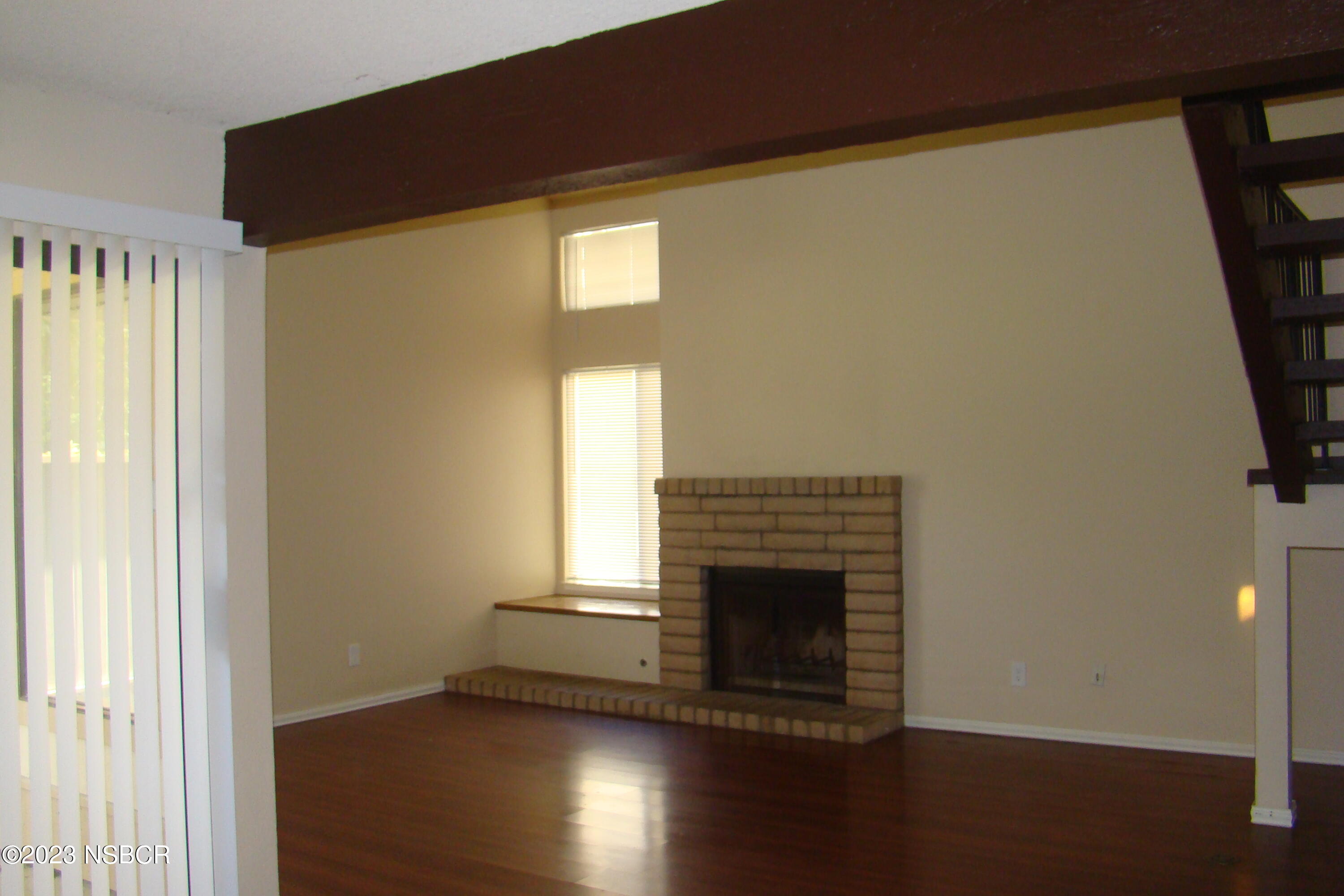 1245 Riverside Drive Lompoc, CA 93436 - Photo 4 of 16 a view of a livingroom with wooden floor and a fireplace