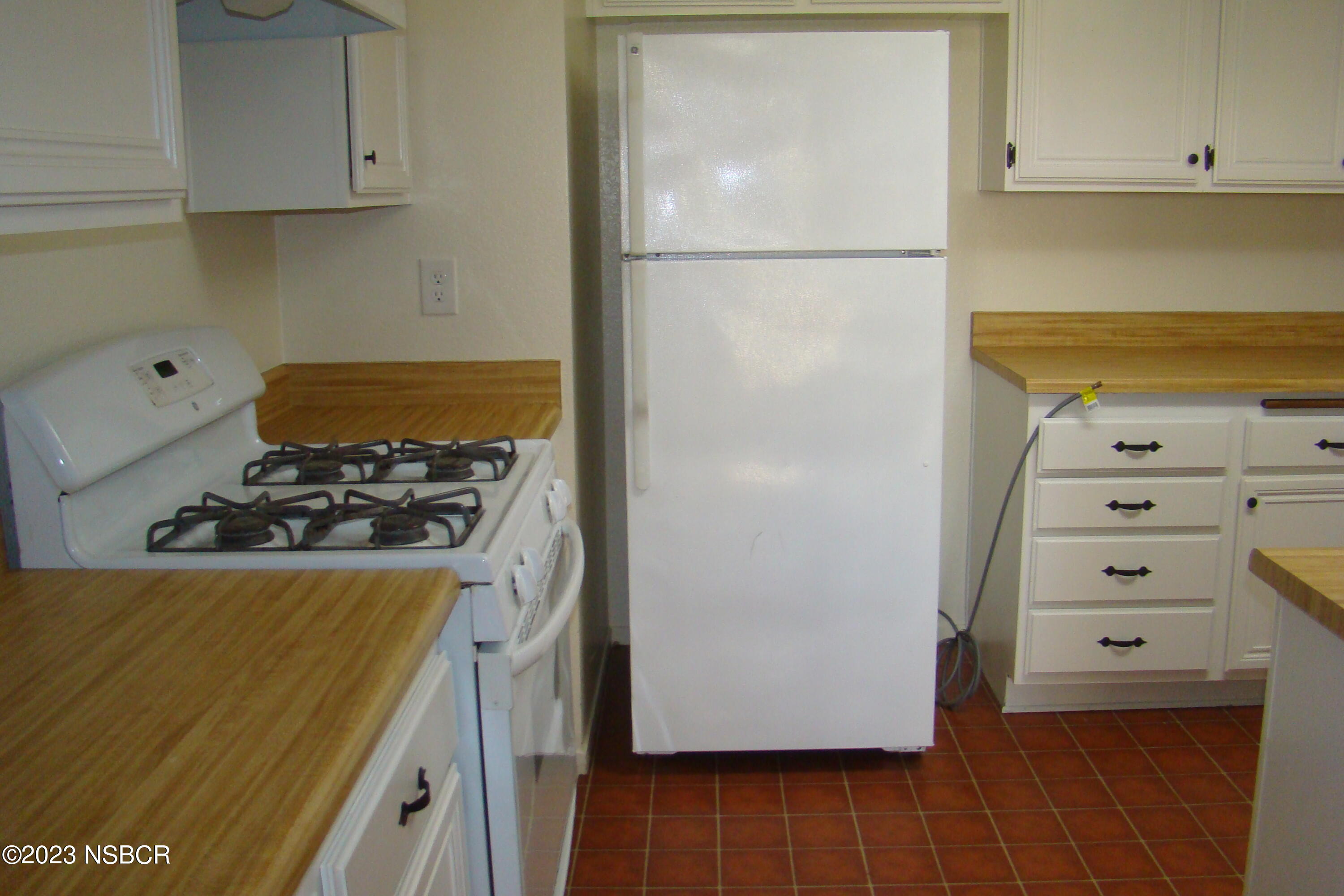 1245 Riverside Drive Lompoc, CA 93436 - Photo 9 of 16 a kitchen with a refrigerator and a stove