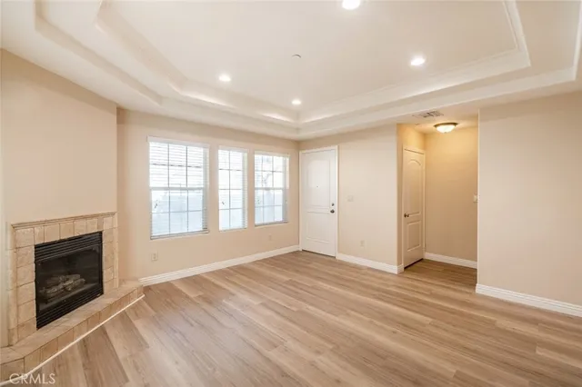 wooden floor in an empty room with a fireplace