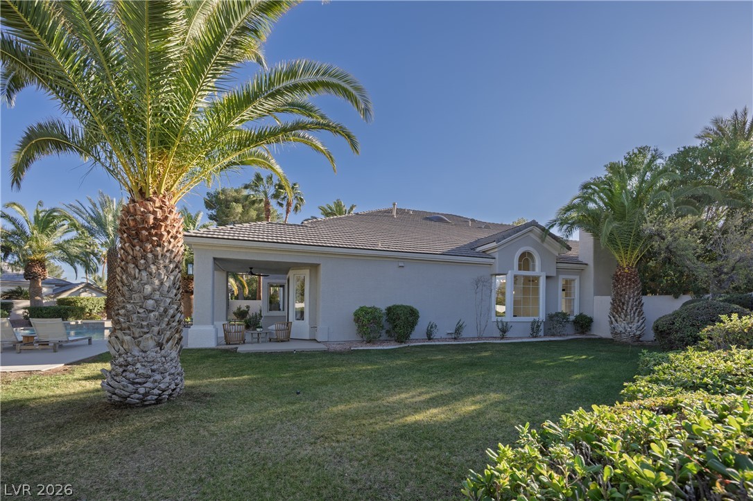 8800 Lusso Las Vegas, NV 89134 - Photo 82 of 85 View of front of property featuring stucco siding, a front yard, a tiled roof, and a patio area