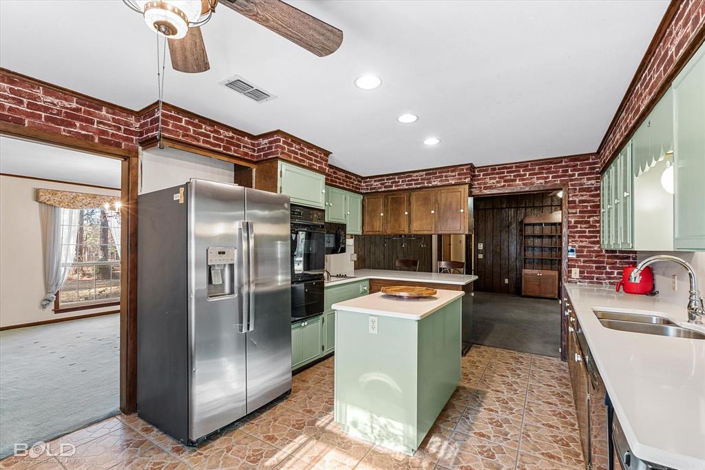 447 Burrow Lane Cotton Valley, LA 71018 - Photo 11 of 39 a kitchen with stainless steel appliances granite countertop a refrigerator a stove and a sink