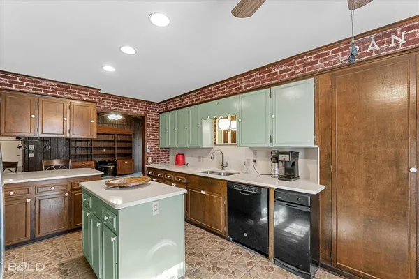 a kitchen that has a sink and a stove in it