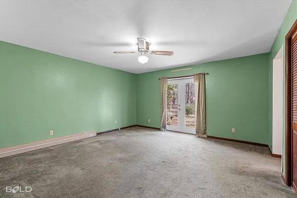 an empty room with fan and window