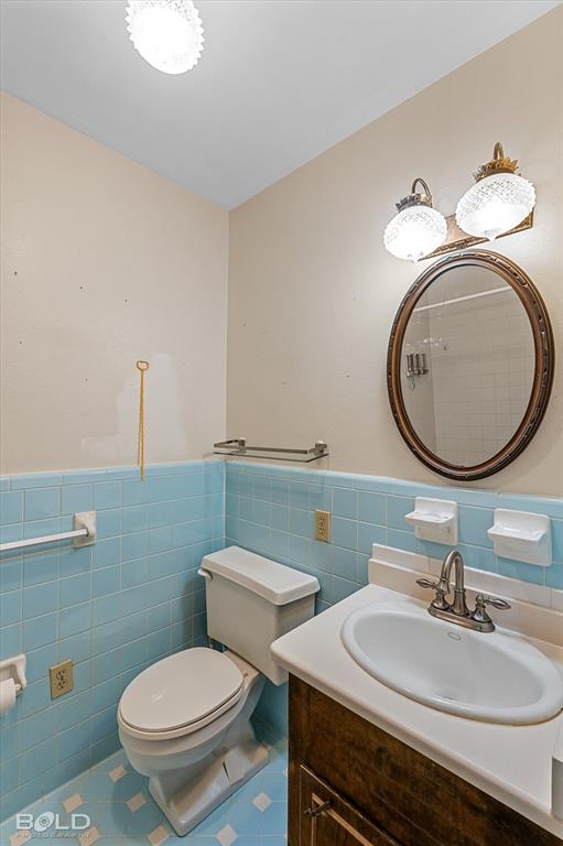 447 Burrow Lane Cotton Valley, LA 71018 - Photo 16 of 39 a bathroom with a granite countertop toilet a sink and a mirror