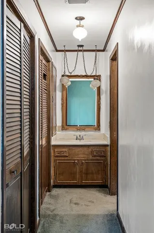a bathroom with a granite countertop toilet sink and mirror