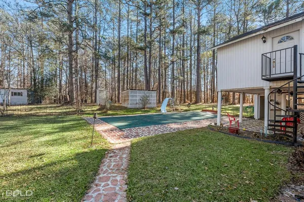 a view of a house with backyard and sitting area