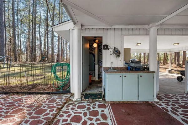 a kitchen with granite countertop a refrigerator and a sink