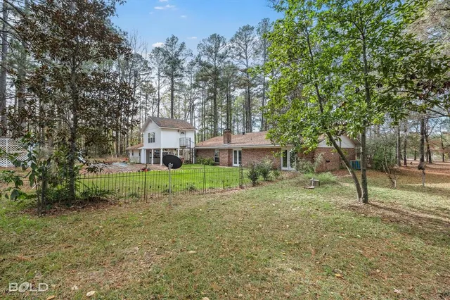 a living room with a gaming machine and chairs