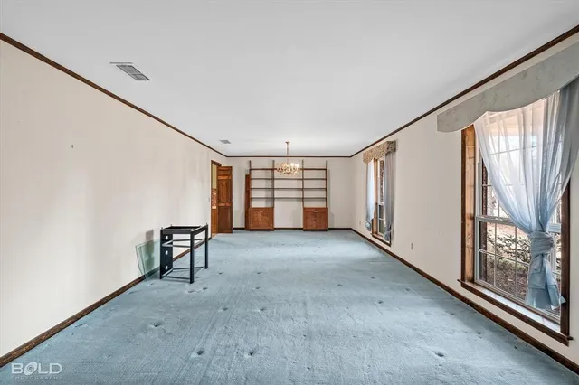 a view of a livingroom with a ceiling fan and window