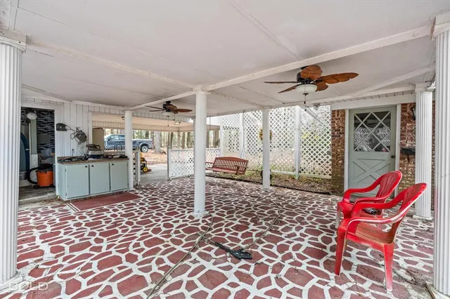 an aerial view of residential houses with city and green space