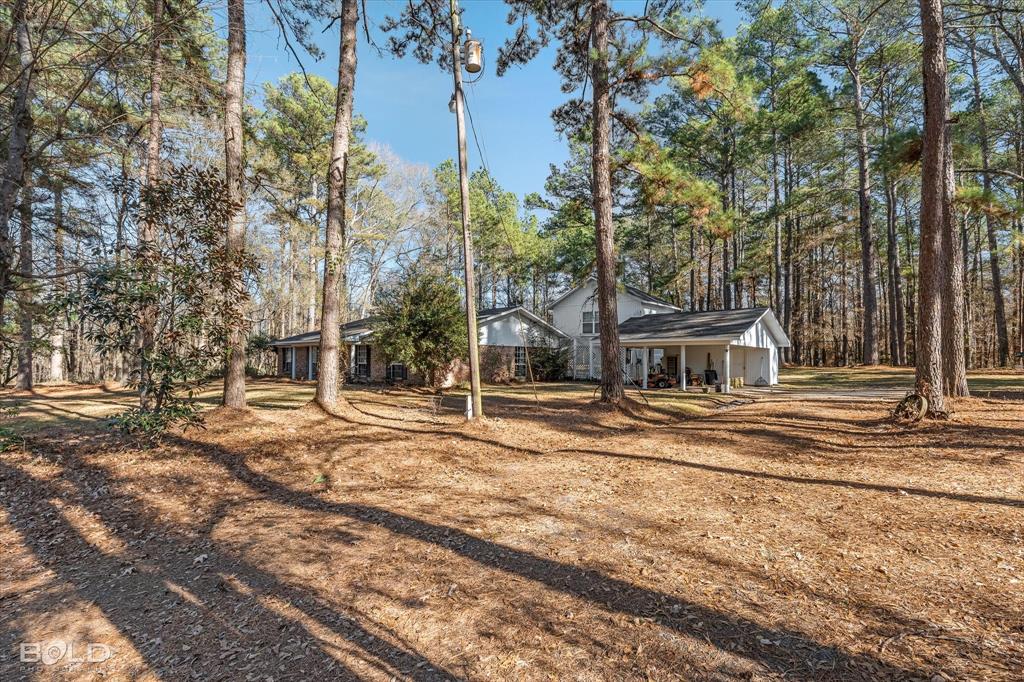 447 Burrow Lane Cotton Valley, LA 71018 - Photo 36 of 39 a view of the house with trees and a big yard